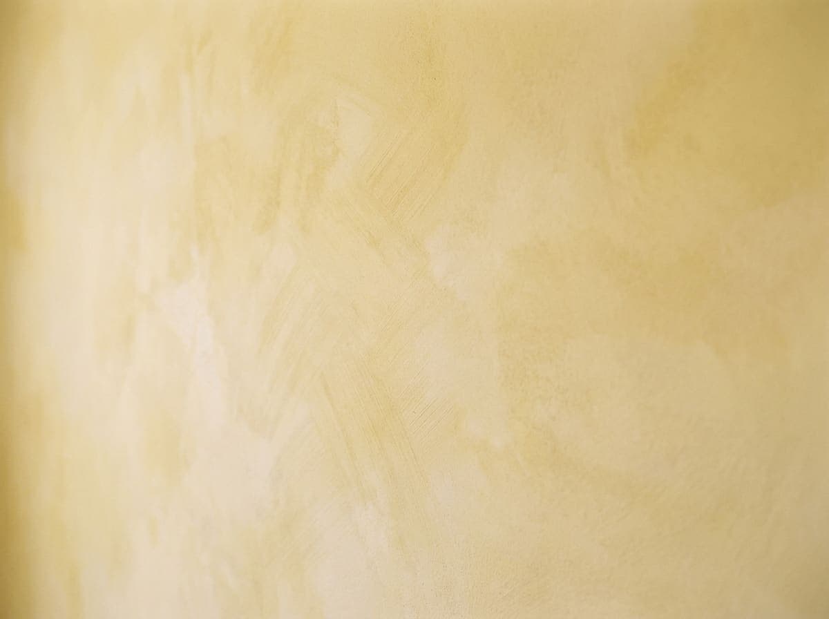 Close-up of butter yellow lime wash brushwork